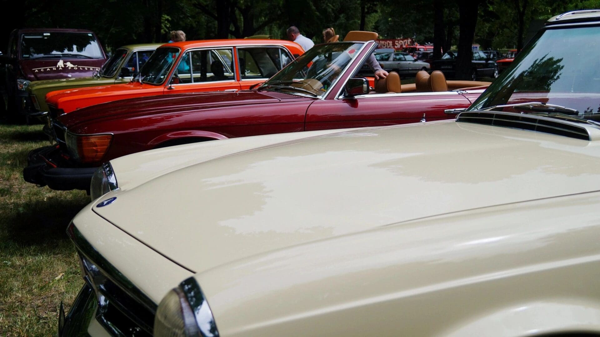 A group of cars parked in front of each other.